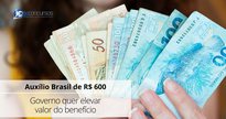 Uma mulher segura notas de dinheiro - Canva - Auxílio Brasil de R$ 600