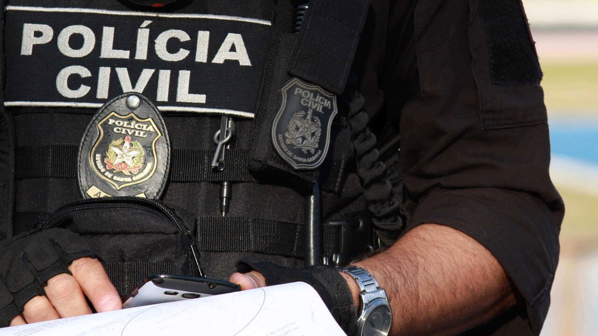 Policial Civil com distintivo e uniforme na cor preta